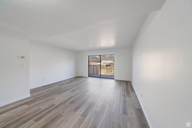 123 E 2nd Ave N Unit T-9, Salt Lake City, UT 84103 - unfurnished room with a textured ceiling, baseboards, and wood finished floors