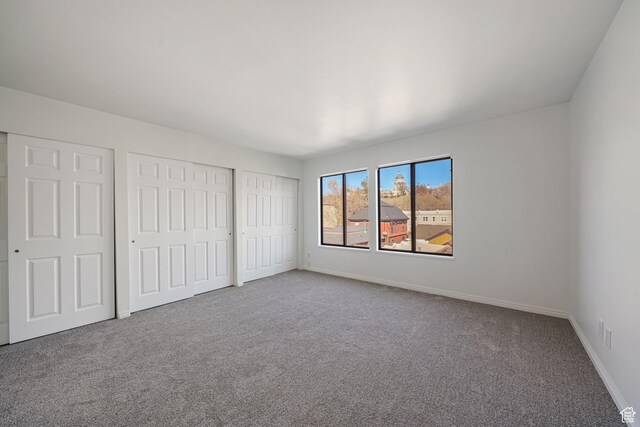 123 E 2nd Ave N Unit T-9, Salt Lake City, UT 84103 - unfurnished bedroom with carpet flooring, baseboards, and multiple closets