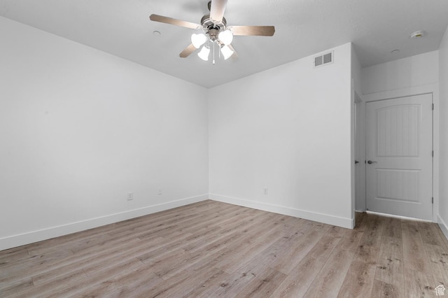 spare room with visible vents, baseboards, a ceiling fan, and light wood-style floors