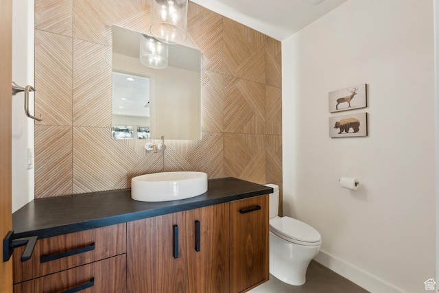 3599 Daybreaker Dr, Park City, UT 84098 - bathroom featuring toilet, backsplash, vanity, baseboards, and tile walls