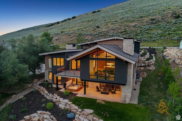 3599 Daybreaker Dr, Park City, UT 84098 - back of property with a chimney, a patio, and stone siding