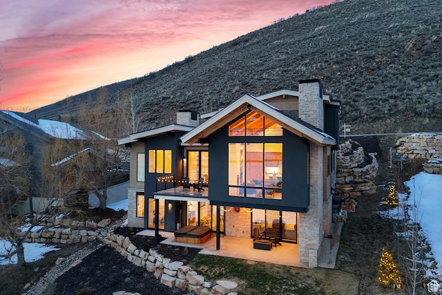 3599 Daybreaker Dr, Park City, UT 84098 - back of house with french doors, a patio, a mountain view, and a chimney