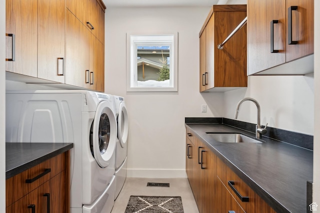 3599 Daybreaker Dr, Park City, UT 84098 - clothes washing area featuring independent washer and dryer, baseboards, a sink, visible vents, and cabinet space
