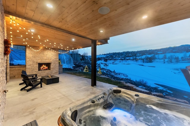 3599 Daybreaker Dr, Park City, UT 84098 - view of patio / terrace featuring an outdoor stone fireplace and an outdoor hot tub