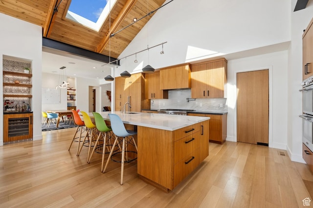 3599 Daybreaker Dr, Park City, UT 84098 - kitchen with modern cabinets, light wood-style floors, and beverage cooler