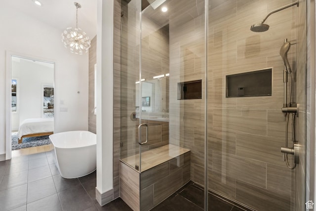 3599 Daybreaker Dr, Park City, UT 84098 - full bathroom featuring a shower stall, a soaking tub, tile patterned floors, connected bathroom, and a notable chandelier