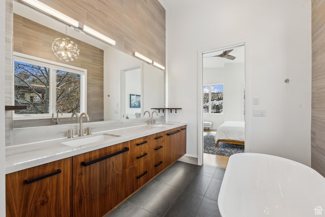 3599 Daybreaker Dr, Park City, UT 84098 - ensuite bathroom with double vanity, a sink, a freestanding tub, and tile patterned flooring