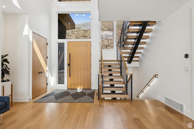 3599 Daybreaker Dr, Park City, UT 84098 - foyer with stairway, a high ceiling, wood finished floors, baseboards, and visible vents