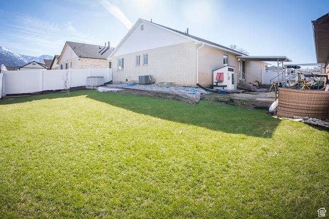880 E 5700 S, South Ogden, UT 84405 - rear view of property featuring central AC, entry steps, a lawn, fence, and brick siding