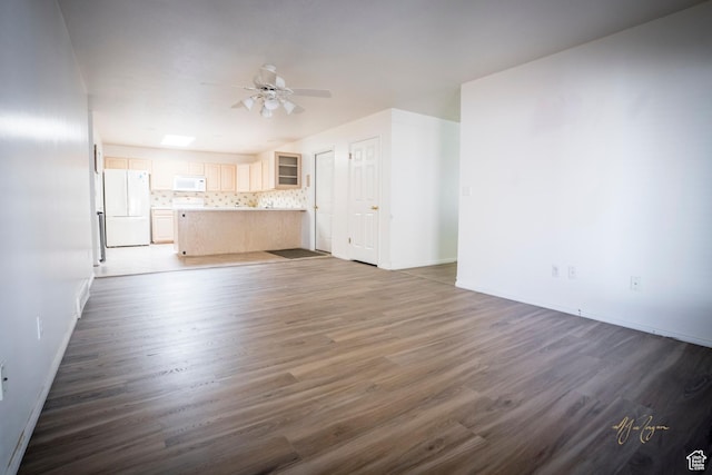 880 E 5700 S, South Ogden, UT 84405 - unfurnished living room featuring ceiling fan, wood finished floors, and baseboards
