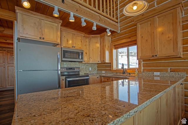 3186 S Sweetwater Pkwy, Garden City, UT 84028 - kitchen with appliances with stainless steel finishes, a sink, track lighting, light stone counters, and light brown cabinets