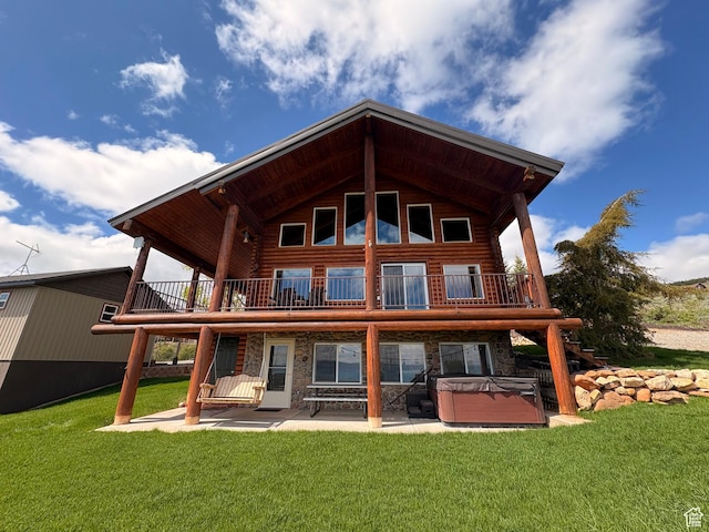 3186 S Sweetwater Pkwy, Garden City, UT 84028 - back of house with a hot tub, log siding, a patio area, and a balcony