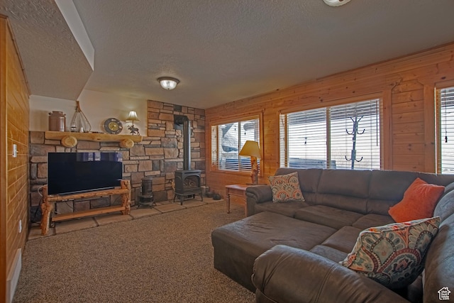 3186 S Sweetwater Pkwy, Garden City, UT 84028 - carpeted living room featuring a textured ceiling, wood walls, and a wood stove