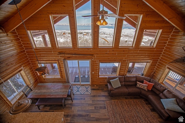 3186 S Sweetwater Pkwy, Garden City, UT 84028 - living area with rustic walls, wood finished floors, a water view, plenty of natural light, and high vaulted ceiling