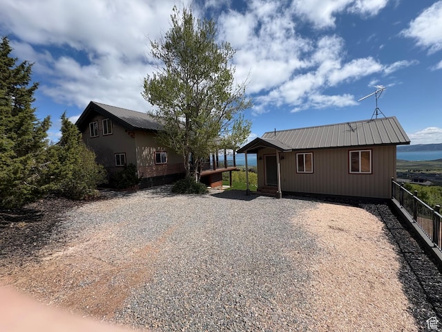 3186 S Sweetwater Pkwy, Garden City, UT 84028 - view of front of home with metal roof and driveway