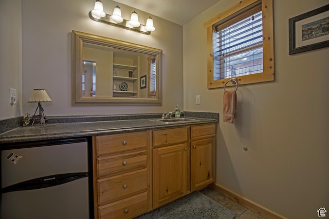 3186 S Sweetwater Pkwy, Garden City, UT 84028 - bathroom featuring double vanity, tile patterned flooring, and baseboards