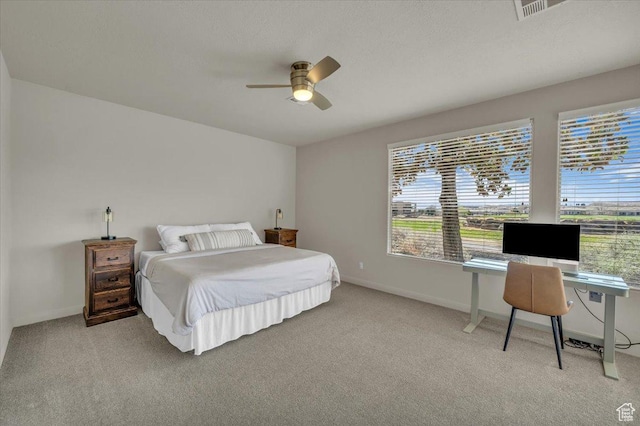 409 N Country Ln Unit 3, St George, UT 84770 - bedroom featuring visible vents, light colored carpet, baseboards, and ceiling fan