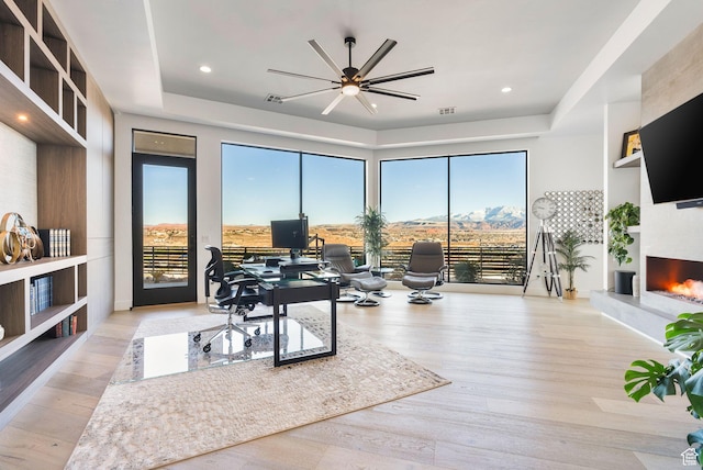 home office with wood finished floors, visible vents, recessed lighting, ceiling fan, and a large fireplace