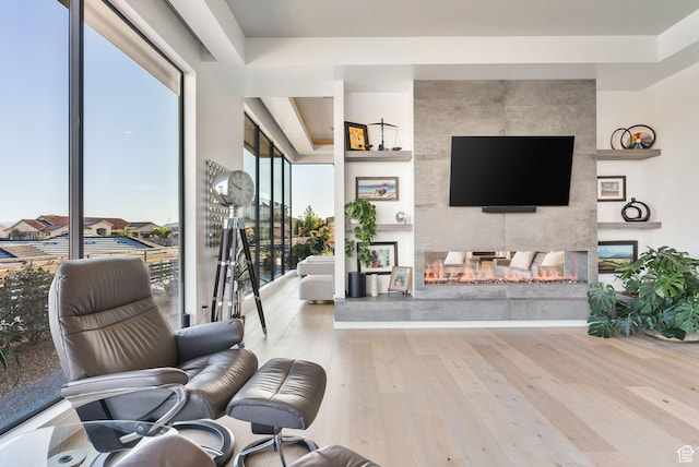 living room featuring wood finished floors and a multi sided fireplace
