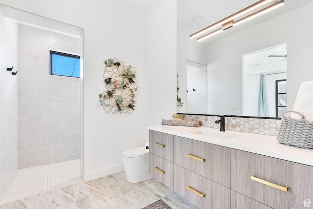bathroom featuring a wealth of natural light, toilet, vanity, and walk in shower