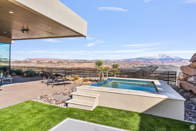 view of pool with a mountain view, a patio, and fence
