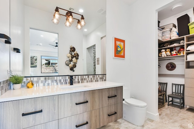 bathroom featuring vanity, a ceiling fan, visible vents, decorative backsplash, and toilet