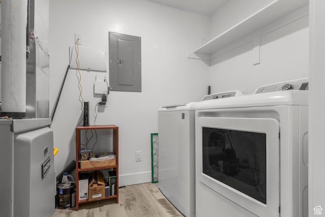 875 S Depot St Unit 344B, Clearfield, UT 84015 - clothes washing area featuring baseboards, electric panel, laundry area, wood finished floors, and washer and dryer