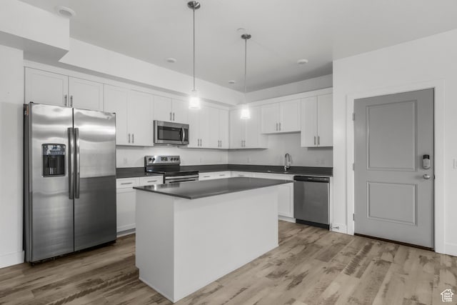 875 S Depot St Unit 344B, Clearfield, UT 84015 - kitchen featuring dark countertops, light wood-style flooring, appliances with stainless steel finishes, and a sink
