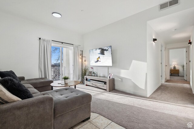 1134 E 3300 S Unit 216, Millcreek, UT 84106 - living area with light carpet, visible vents, baseboards, and light tile patterned floors