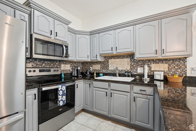 1134 E 3300 S Unit 216, Millcreek, UT 84106 - kitchen with a sink, light tile patterned flooring, backsplash, and stainless steel appliances