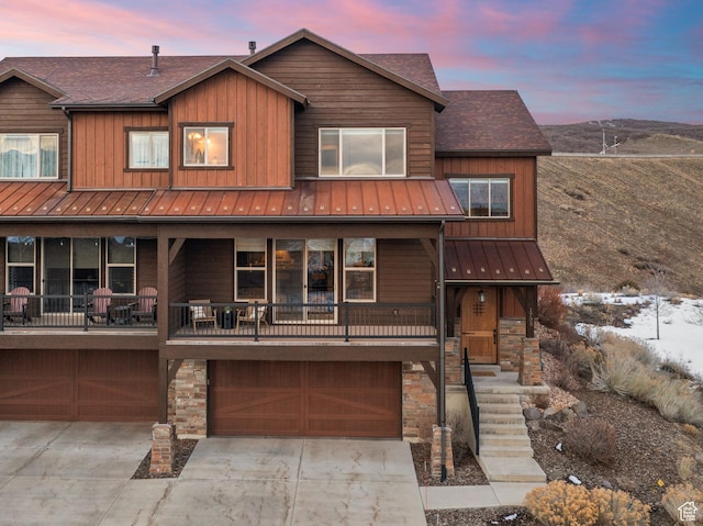 view of front of house with stone siding, concrete driveway, and a garage