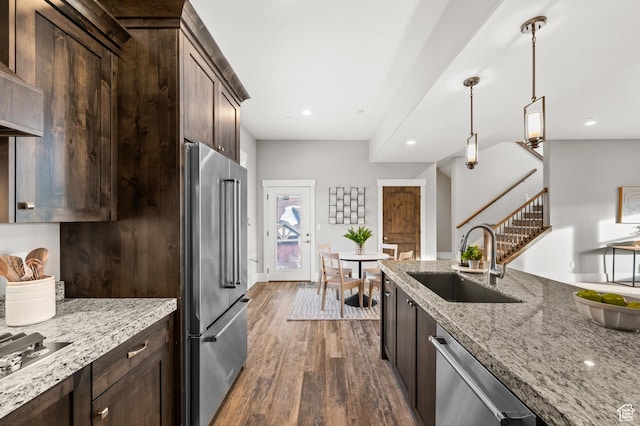 1733 E Viewside Cir, Hideout, UT 84036 - kitchen featuring a sink, stainless steel appliances, dark brown cabinets, dark wood finished floors, and light stone counters