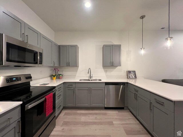 3578 S 805 E Unit 237, Millcreek, UT 84106 - kitchen featuring stainless steel appliances, gray cabinetry, a peninsula, and a sink