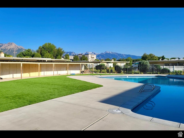 3578 S 805 E Unit 237, Millcreek, UT 84106 - view of pool with a yard, a mountain view, a fenced in pool, and fence