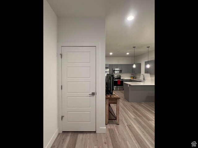 3578 S 805 E Unit 237, Millcreek, UT 84106 - kitchen featuring a kitchen breakfast bar, gray cabinets, appliances with stainless steel finishes, light countertops, and light wood finished floors
