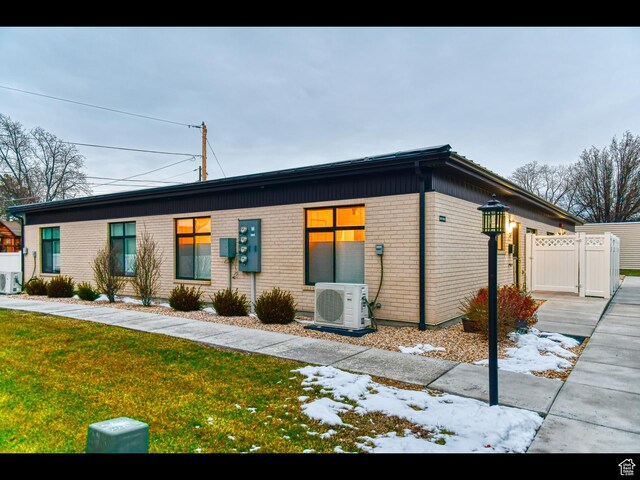 3578 S 805 E Unit 237, Millcreek, UT 84106 - view of front of property with a gate, a front yard, brick siding, fence, and ac unit