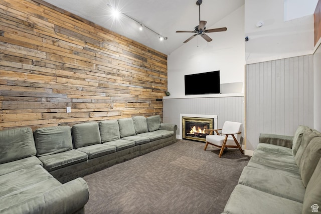 6948 W Dusty Rose Cir, Herriman, UT 84065 - carpeted living room featuring high vaulted ceiling, track lighting, a glass covered fireplace, wooden walls, and ceiling fan