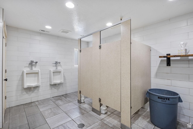 6948 W Dusty Rose Cir, Herriman, UT 84065 - full bathroom with visible vents, recessed lighting, a walk in shower, and tile walls