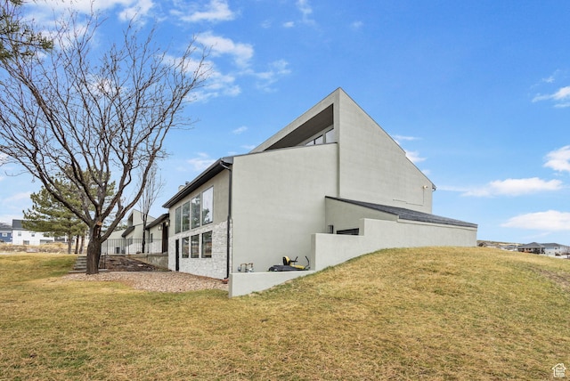 6948 W Dusty Rose Cir, Herriman, UT 84065 - view of home's exterior with stucco siding and a yard