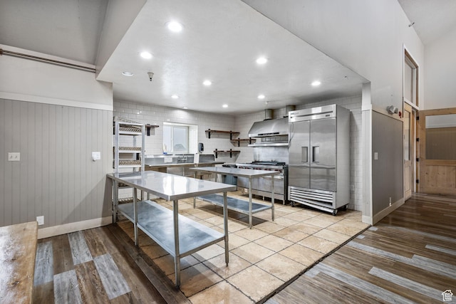 6948 W Dusty Rose Cir, Herriman, UT 84065 - kitchen featuring wall chimney range hood, high quality appliances, light wood-style flooring, and recessed lighting