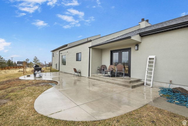 6948 W Dusty Rose Cir, Herriman, UT 84065 - back of house featuring a patio, french doors, a chimney, and stucco siding