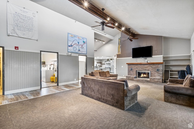 6948 W Dusty Rose Cir, Herriman, UT 84065 - living room featuring a brick fireplace, ceiling fan, beam ceiling, wood finished floors, and high vaulted ceiling
