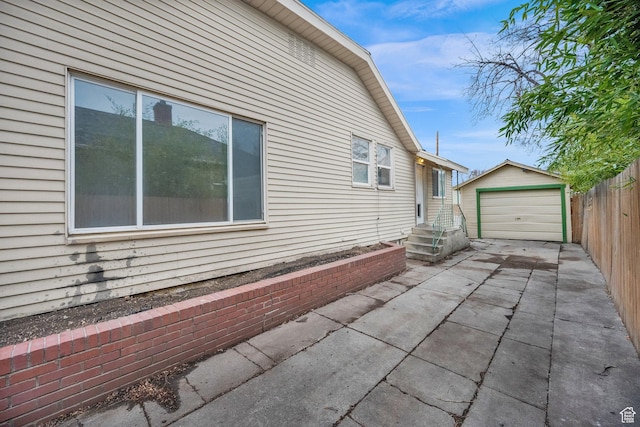 641 E Coatsville Ave S, Salt Lake City, UT 84105 - view of side of home with an outbuilding, driveway, a detached garage, and fence