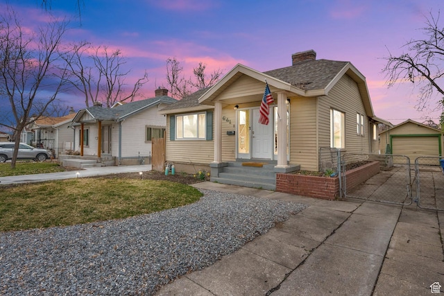 641 E Coatsville Ave S, Salt Lake City, UT 84105 - bungalow-style house with a gate, fence, concrete driveway, an outdoor structure, and a chimney