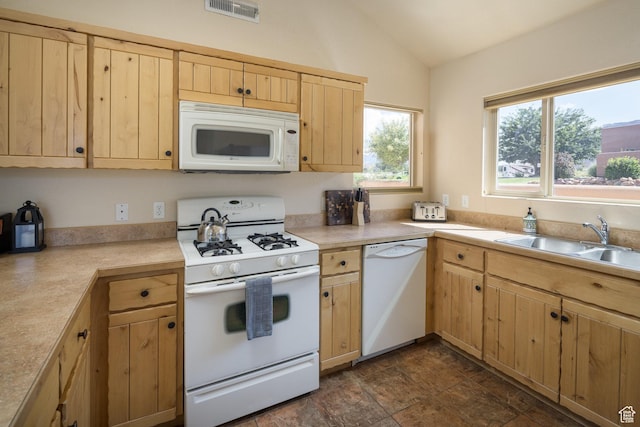 3686 S Spanish Valley Dr Unit U-3, Moab, UT 84532 - kitchen with visible vents, light brown cabinets, vaulted ceiling, white appliances, and a sink
