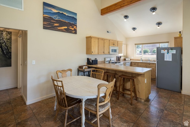 3686 S Spanish Valley Dr Unit U-3, Moab, UT 84532 - dining area with visible vents, beam ceiling, high vaulted ceiling, and baseboards