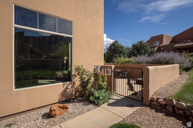 3686 S Spanish Valley Dr Unit U-3, Moab, UT 84532 - exterior space featuring stucco siding, fence, and a gate