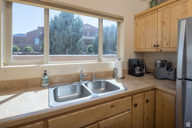 3686 S Spanish Valley Dr Unit U-3, Moab, UT 84532 - kitchen with light brown cabinetry, light countertops, freestanding refrigerator, and a sink