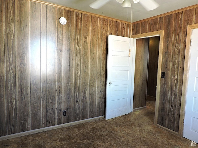unfurnished bedroom with carpet floors and wooden walls