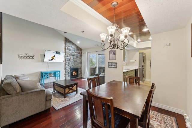 7035 N 2200 W Unit 3W, Park City, UT 84098 - dining room with baseboards, a tray ceiling, lofted ceiling, dark wood-type flooring, and a chandelier